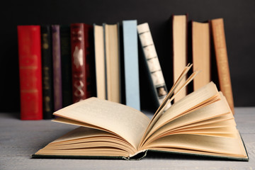 Open hardcover book on grey wooden table