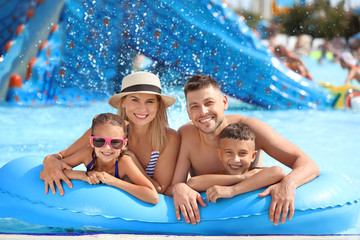 Happy family resting in aqua park