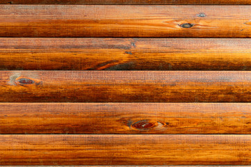 Wooden rustic background. Bright orange planks in natural daylight. Background for autumn projects.