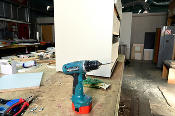 Photo of an industrial workshop for the manufacture and coloring of parts. Showing tools for work. The photo was taken in a really working manufactory.