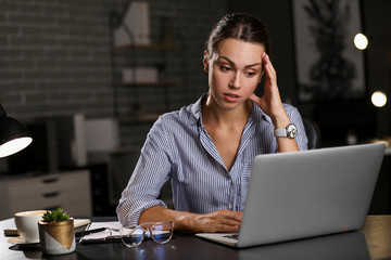 Tired businesswoman trying to meet deadline in office