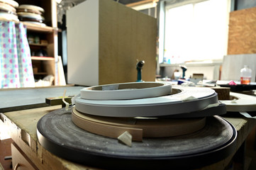 Photo of an industrial workshop for the manufacture and coloring of parts. Showing tools for work....
