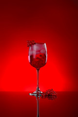 Glass of tasty cocktail on dark color background
