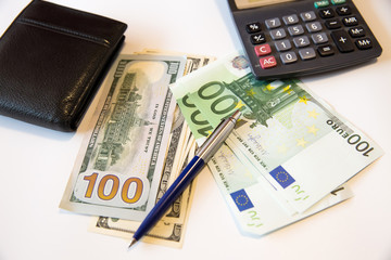 Currency in the wallet and on the table.