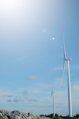 Fototapeta premium Windmills for electric power production is located at Pak Panang District, Nakhon Si Thammarat, Thailand. Wind power is one of clean and renewable natural sources of energy. Alternative energy concept