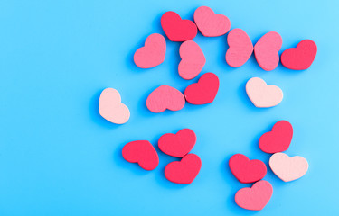Fototapeta na wymiar Pink hearts on a blue background