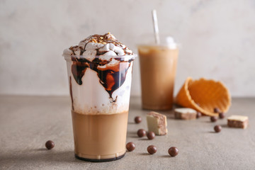 Cup of tasty frappe coffee on table