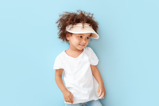 Portrait of little African-American girl on color background