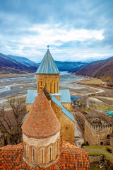 Old Castle Church in Cloudy Mountain Landscape - 296260270