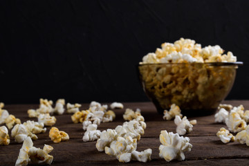 Air salty popcorn.A bowl of popcorn on a wooden table.Salt popcorn on the wooden background .  With space for text.Top view.popcorn texture.Chees .