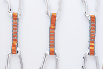 Adventure time. Many of the multi colored carabiners on lying on the white table