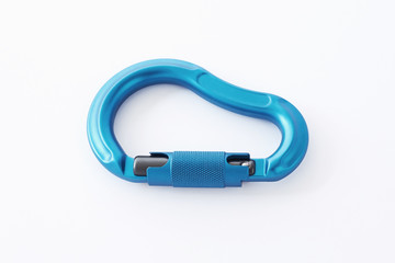 Nice lighting. Isolated photo of climbing equipment - blue colored part of carabiner