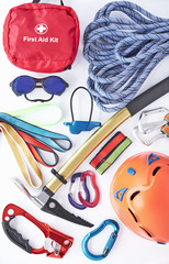Different colors. Top view. Climbing equipment for the safeness lying on the white table. Conception of extreme sports