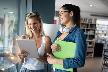 Happy group of students studying and learning together in college