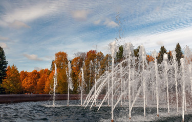 Fountain in the autumn park on a bright sunny day