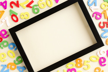 Colored wooden numbers composition on beige background.