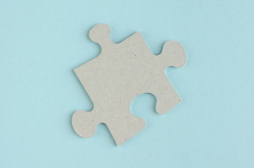 Fototapeta premium Gray puzzles composition on blue background. Flat lay