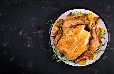 Baked turkey or chicken. The Christmas table is served with a turkey, decorated with bright tinsel....