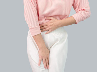 Unhealthy Asian women suffer from abdominal pain, irregular menstruation, isolated on a grey...