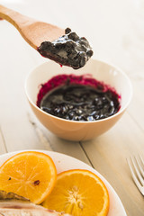 Paddle with jam near oranges