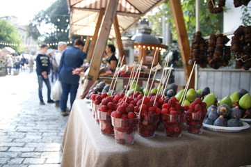 GEORGIA, TBILISI - OCTOBER 5, 2019: Feast in Tbilisi. Harvest festival Tbilisoba. Fresh fruit on the counter. Raspberries in glasses for sale on the street in autumn