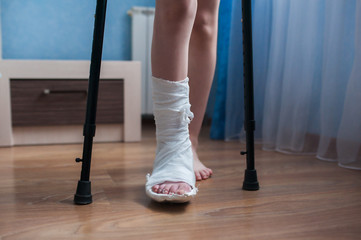 Broken leg in plaster and crutches