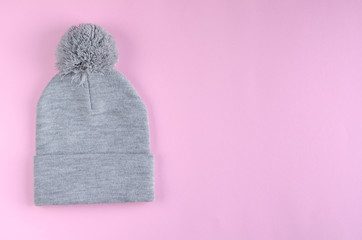 Gray cotton hat composition on pink background. Flat lay.