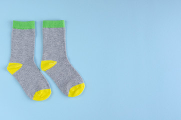 Kids socks composition on blue background. Flat lay.
