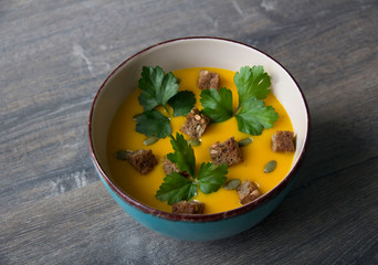 Pumpkin cream soup with pumpkin seeds and parsley