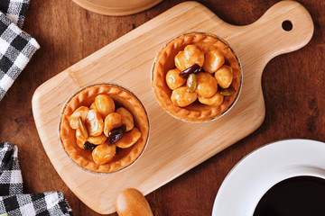    Macadamia nuts tart on wooden table 