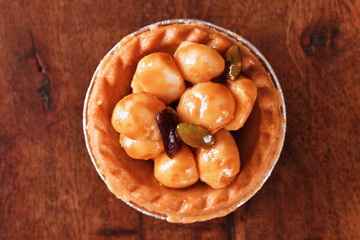    Macadamia nuts tart on wooden table 