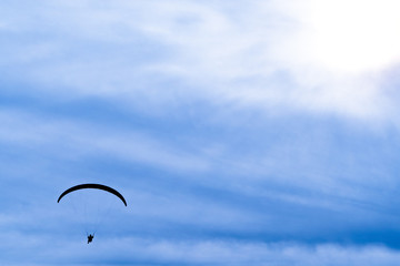 paraglider in blue sky