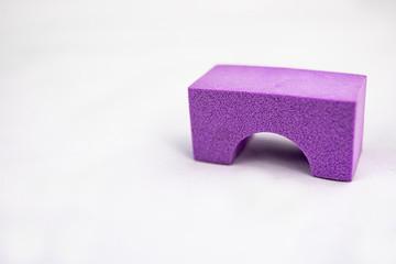 Violet toy sponge jumper on white background