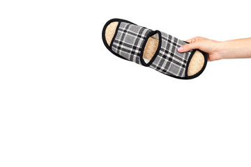 Hand with striped cotton slippers, child footwear.