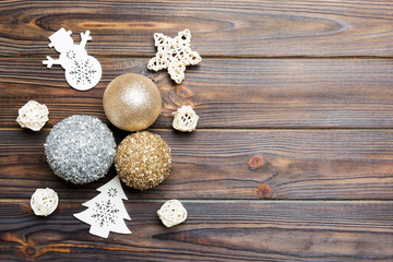 Top view of festive winter composition on wooden background with empty space for your design. Christmas baubles and decorations. New Year concept