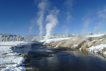 River with geysers during winter in Yellowstone National Park, United States