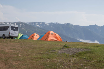 tourist tent camping in mountains. Summer adventure vacations outdoor