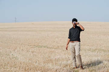 Naklejka na ściany i meble South asian agronomist farmer inspecting wheat field farm. Agriculture production concept.
