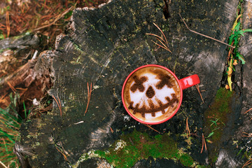 Coffee cup as jack o lantern pumpkin