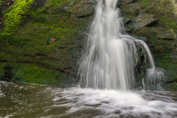 waterfall over mossy rocks