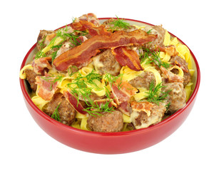 Meatball and smoky bacon pasta meal isolated on a white background
