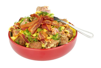 Meatball and smoky bacon pasta meal isolated on a white background