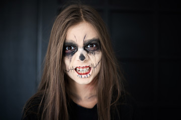 A girl with scary make up for Halloween Holiday and day of the dead