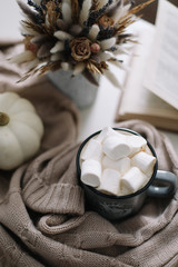 Seasonal home autumn decoration with dried flowers and white pumpkin. Cozy warm image, hygge style