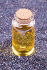 Poppy seeds with essential oil in a small jar