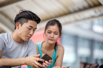 young couple taking self portrait with mobile phone