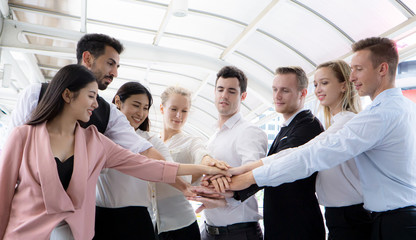 Low Angle View Of Business Coworkers Doing Fist Bump While Standing Outdoors