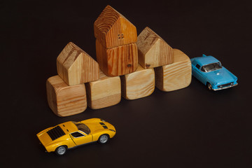 Wooden building blocks for kids. Toy building made of wooden cubes. Toy car model among wooden...