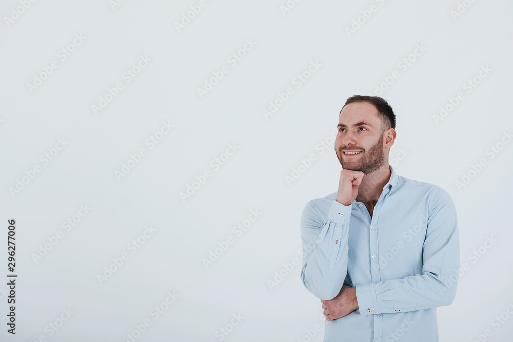 Wall mural Man in official clothes stands against white background in the studio