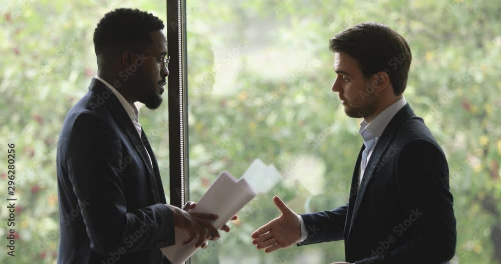 Sticker Two diverse male partners designers talking handshaking standing in office